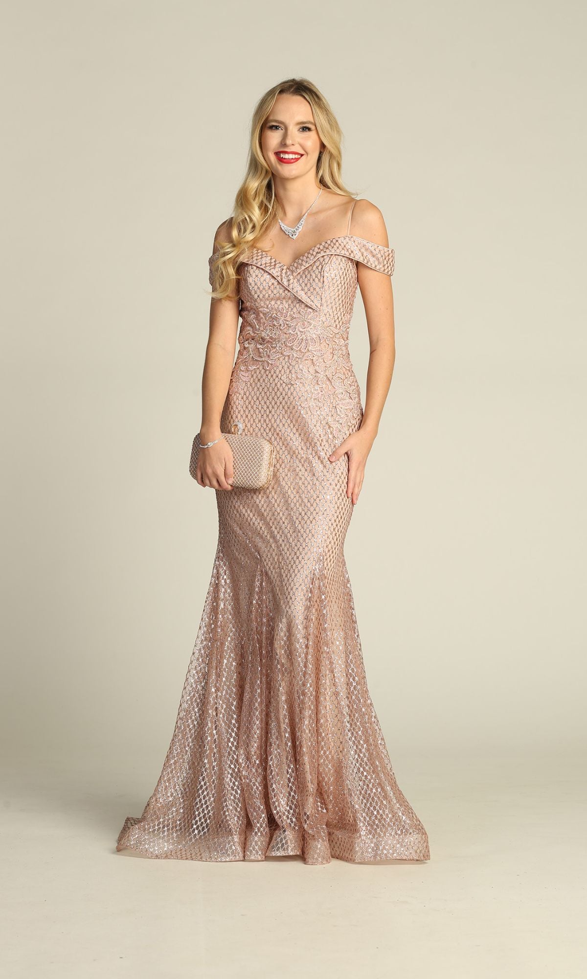 Woman wearing the Off-the-Shoulder Long Prom Dress: Chicas DM4024 in light pink, holding a matching clutch and smiling against a plain background.